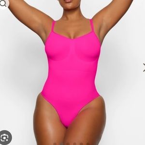 Skims Sculpting Bodysuit with snaps in hot pink